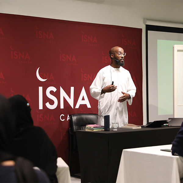 A Muslim speaker talking to a group at an ISNA Canada event