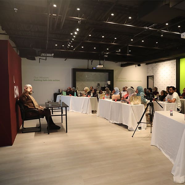 Muslim speaker talking at an ISNA Canada event to an audience