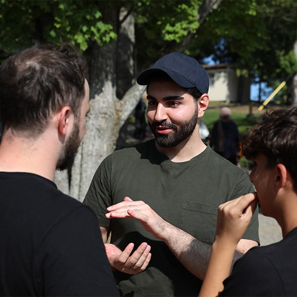 Man speaking with 2 other men at ISNA Canada Event