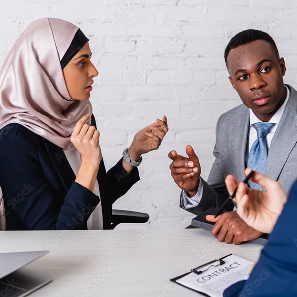 Muslim woman speaking in sign language to a deaf man